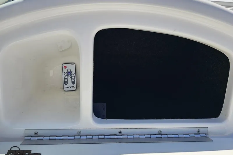 Slide: The Image of Storage compartment with remote control in 2001 Powerquest 280 Silencer boat. - 50