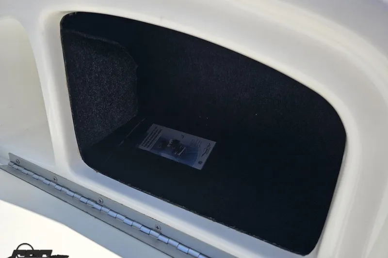 Slide: The Image of Storage compartment of 2001 Powerquest 280 Silencer boat, featuring a carpeted interior. - 51