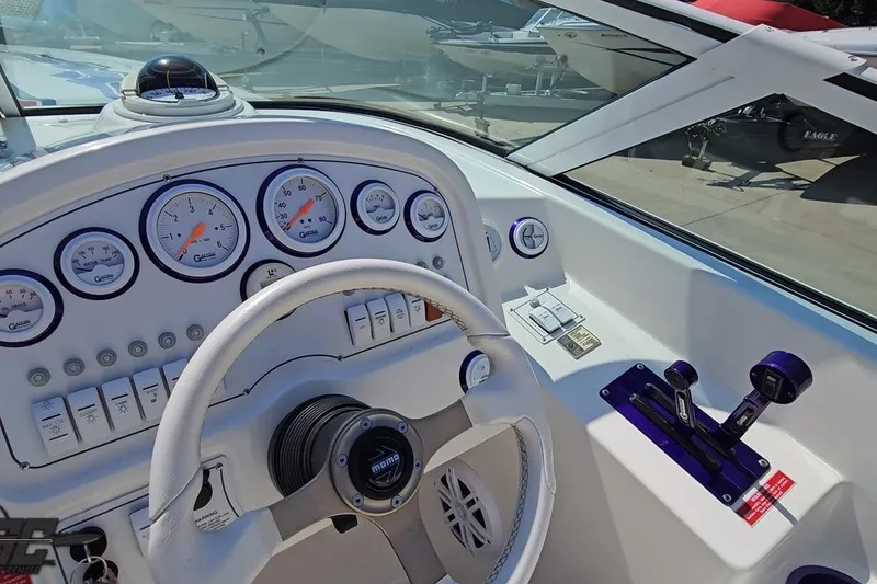Slide: The Image of Cockpit of 2001 Powerquest 280 Silencer boat with steering wheel and gauges. - 54