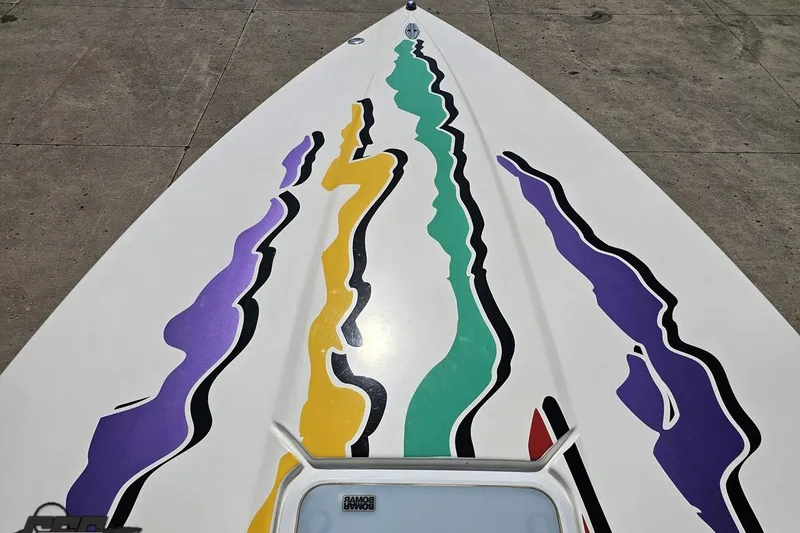 Slide: The Image of 2001 Powerquest 280 Silencer boat with colorful abstract graphics on the deck. - 58