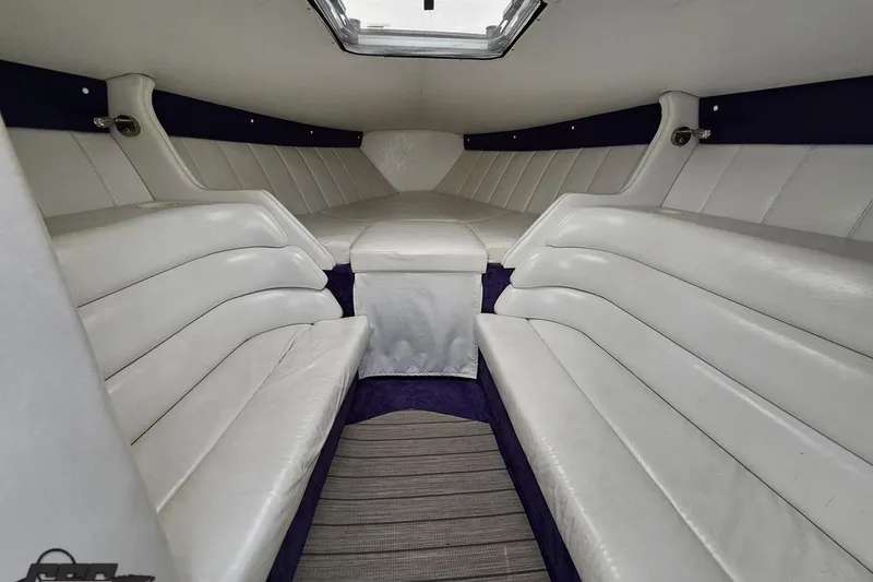 Slide: The Image of Interior cabin of a 2001 Powerquest 280 Silencer boat with white seating. - 63