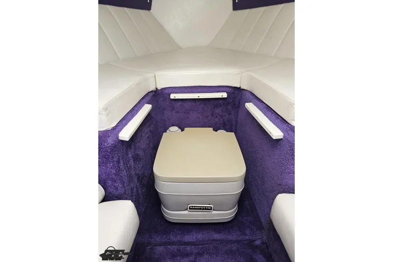 Slide: The Image of Interior of 2001 Powerquest 280 Silencer boat with portable toilet and purple carpeting. - 66