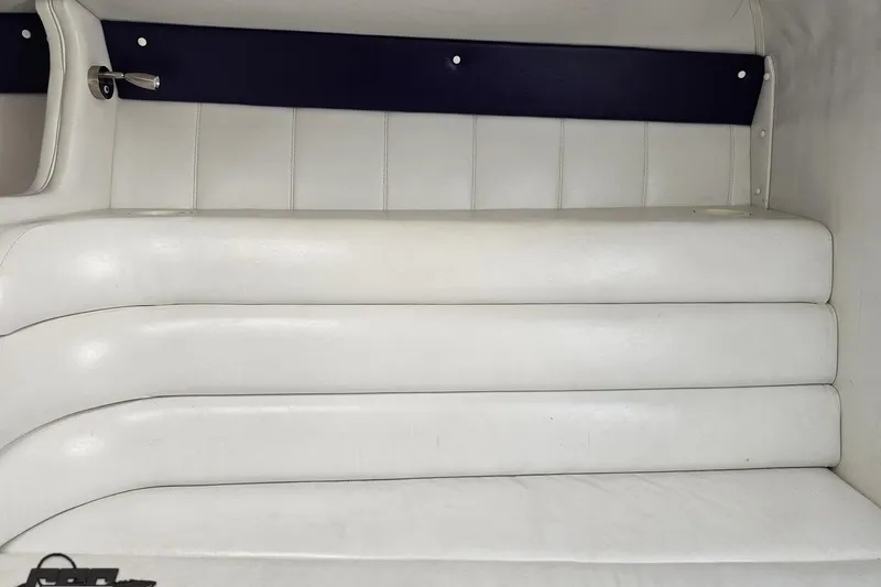 Slide: The Image of Interior seating of a 2001 Powerquest 280 Silencer boat, featuring white leather upholstery. - 67