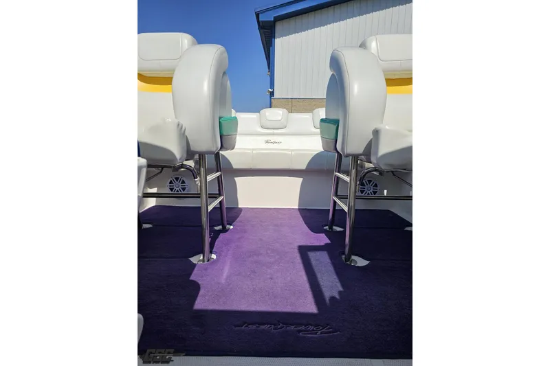 Slide: The Image of Interior of 2001 Powerquest 280 Silencer boat with purple carpet and white seating. - 69