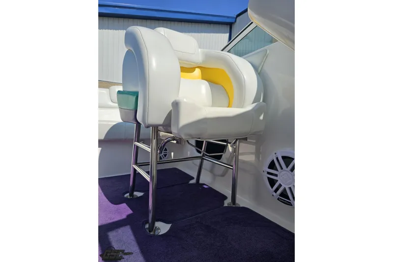 Slide: The Image of Captain's chair on 2001 Powerquest 280 Silencer boat, featuring white and yellow upholstery. - 70