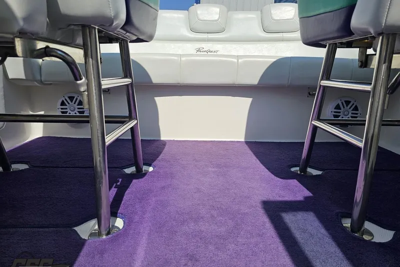 Slide: The Image of Interior of 2001 Powerquest 280 Silencer boat with purple carpet and seating. - 72