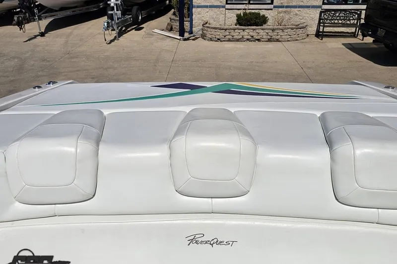 Slide: The Image of 2001 Powerquest 280 Silencer boat with white cushioned seating and sleek design. - 74