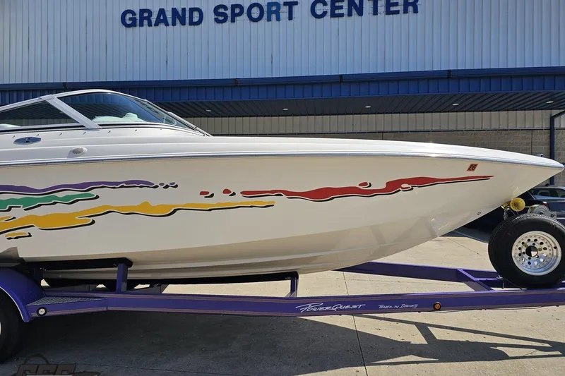Slide: The Image of 2001 Powerquest 280 Silencer boat on trailer at Grand Sport Center. - 9