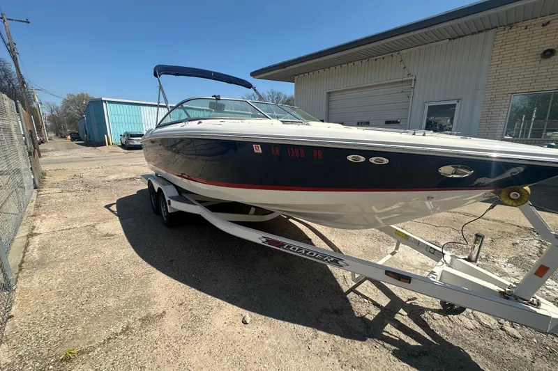 Slide: The Image of 2006 Cobalt 220S boat on trailer, parked outside industrial building. - 14