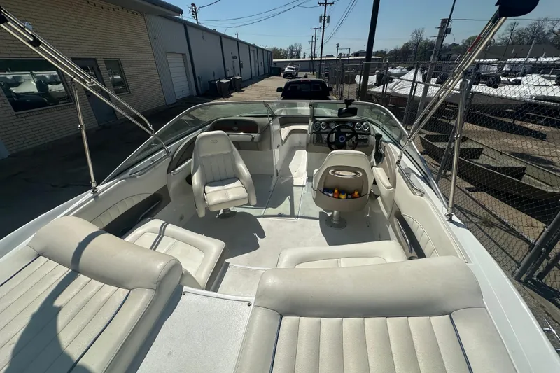 Slide: The Image of Interior of a 2006 Cobalt 220S boat with white seating and steering console. - 15