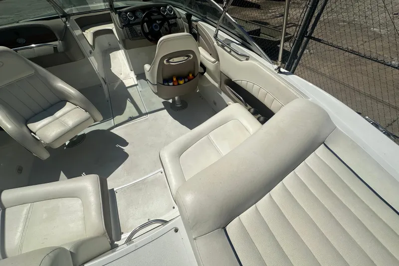 Slide: The Image of Interior of a 2006 Cobalt 220S boat with white leather seating. - 23