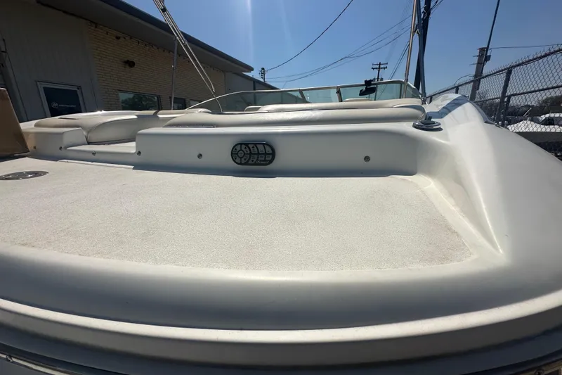 Slide: The Image of 2006 Cobalt 220S boat deck with control panel, parked outdoors. - 24