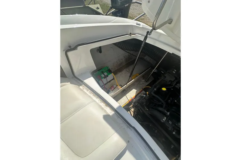 Slide: The Image of Open engine compartment of a 2006 Cobalt 220S boat, showing battery and engine components. - 27