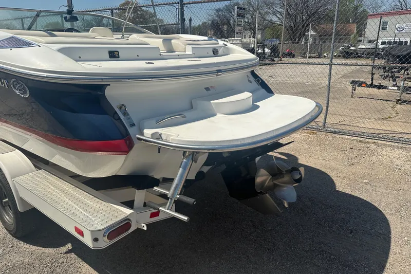 Slide: The Image of 2006 Cobalt 220S boat on trailer, rear view with propeller and swim platform. - 4
