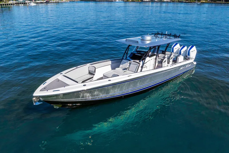 Slide: The Image of 2026 Nor-Tech 390 Sport Center Console boat on clear blue water. - 11