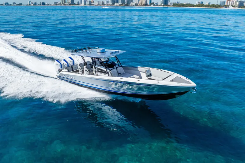 Slide: The Image of 2026 Nor-Tech 390 Sport Center Console cruising on clear blue ocean waters. - 17