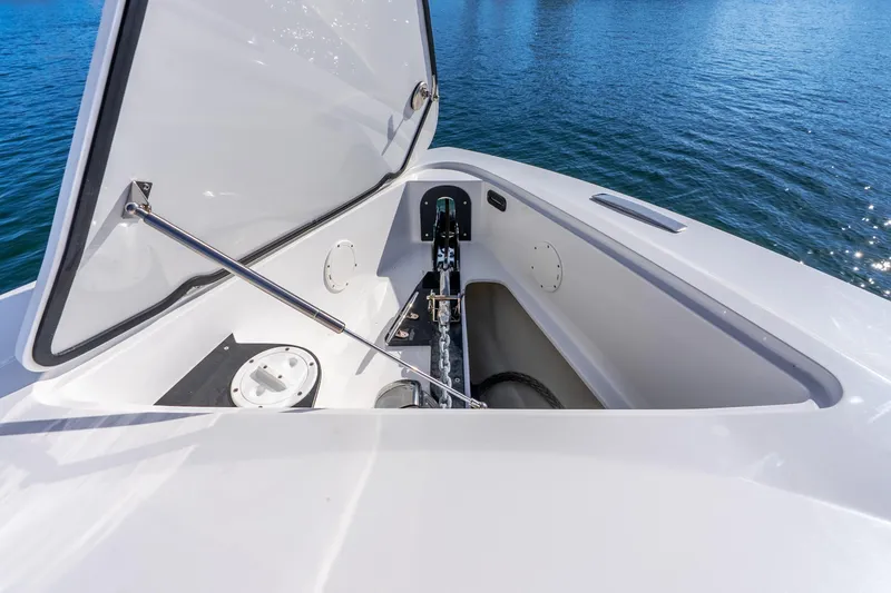 Slide: The Image of 2026 Nor-Tech 390 Sport Center Console anchor compartment, open on calm blue water. - 26