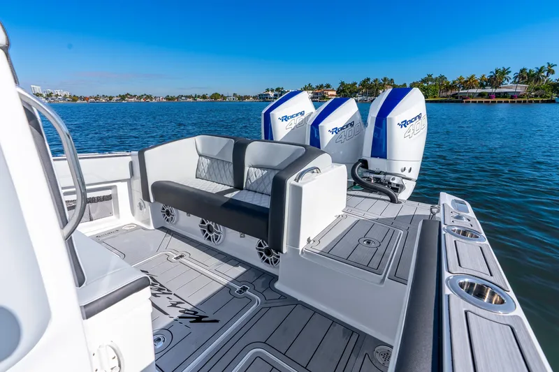 Slide: The Image of 2026 Nor-Tech 390 Sport Center Console boat with triple Racing 400 engines on a sunny day. - 28