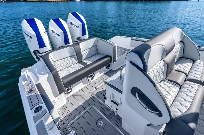 Slide: The Image of 2026 Nor-Tech 390 Sport Center Console with luxurious seating and triple outboard engines. - 29