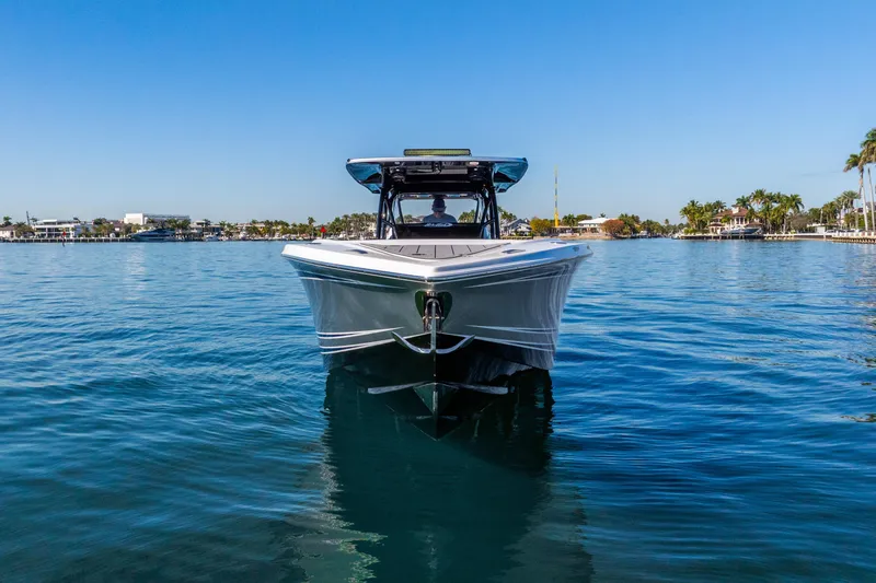 Slide: The Image of 2026 Nor-Tech 390 Sport Center Console boat on calm water, clear blue sky. - 3