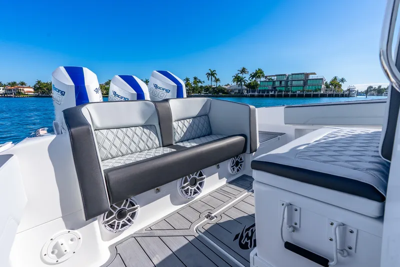 Slide: The Image of 2026 Nor-Tech 390 Sport Center Console boat interior with luxurious seating and powerful engines. - 30