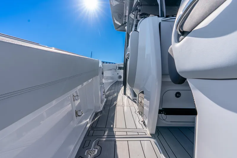 Slide: The Image of 2026 Nor-Tech 390 Sport Center Console boat deck under bright sun. - 34