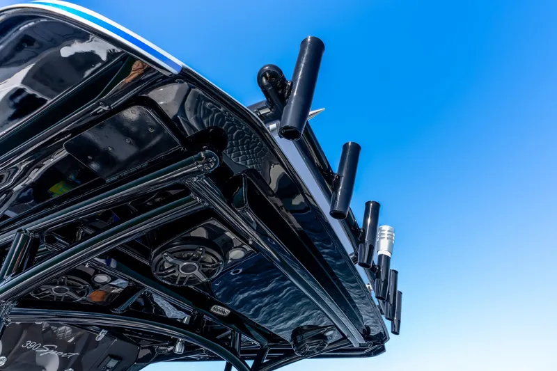 Slide: The Image of 2026 Nor-Tech 390 Sport Center Console, sleek design against clear blue sky. - 36