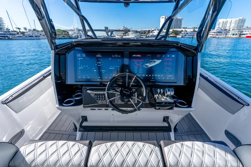 Slide: The Image of 2026 Nor-Tech 390 Sport Center Console helm with advanced navigation displays and luxurious seating. - 37