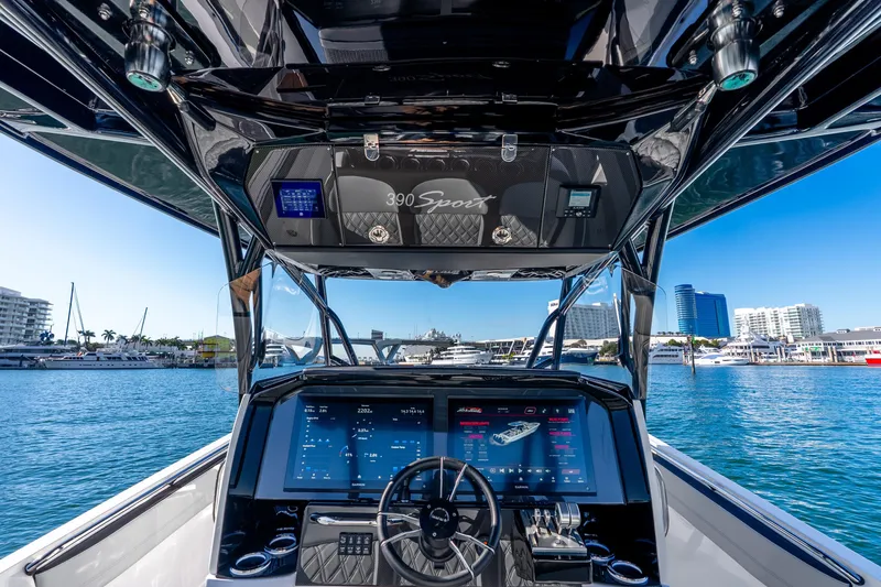 Slide: The Image of 2026 Nor-Tech 390 Sport Center Console boat dashboard with marina view. - 38