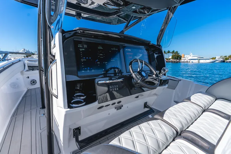Slide: The Image of 2026 Nor-Tech 390 Sport Center Console boat interior with advanced navigation system. - 39