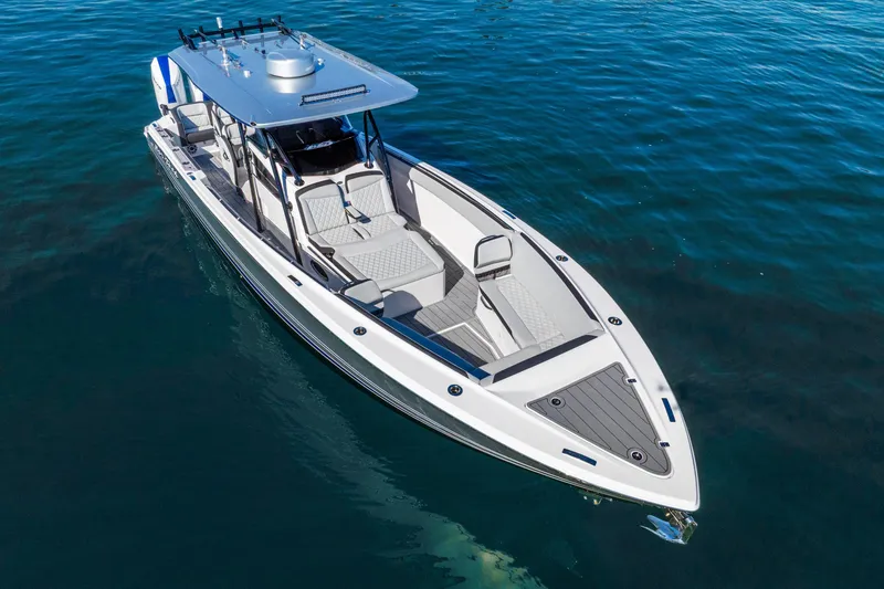 Slide: The Image of 2026 Nor-Tech 390 Sport Center Console boat on clear blue water. - 4