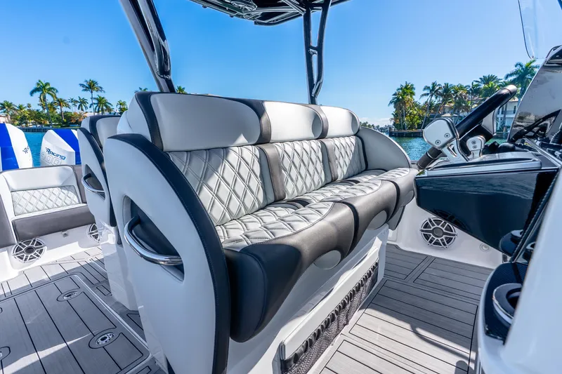 Slide: The Image of Luxurious seating on 2026 Nor-Tech 390 Sport Center Console boat, with sleek design and ocean backdrop. - 41