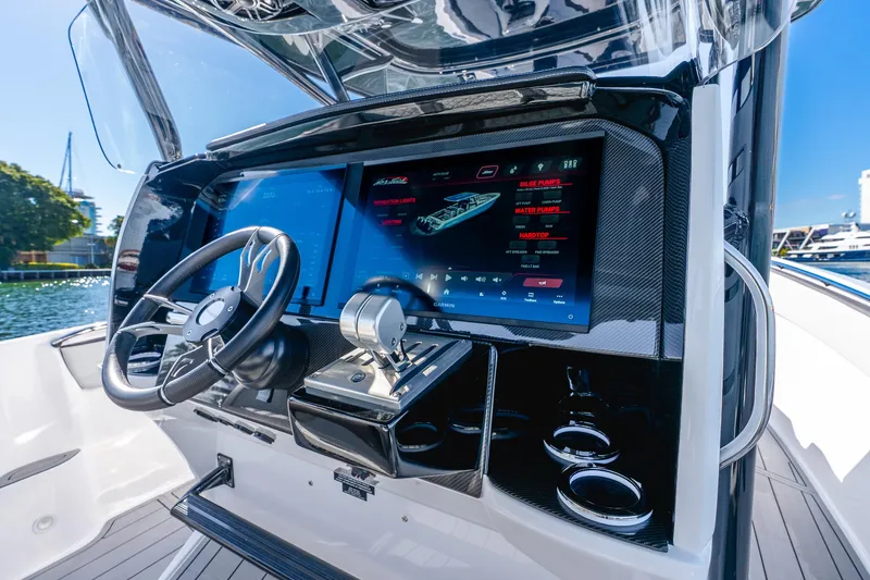 Slide: The Image of 2026 Nor-Tech 390 Sport Center Console dashboard with advanced navigation display. - 42