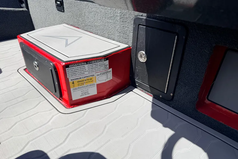 Slide: The Image of 2023 Avid 20 XB boat interior with storage compartments and boater's checklist. - 11