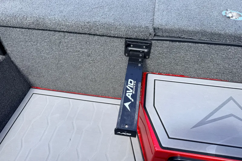 Slide: The Image of Interior of 2023 Avid 20 XB boat with measuring tool and storage compartment. - 14