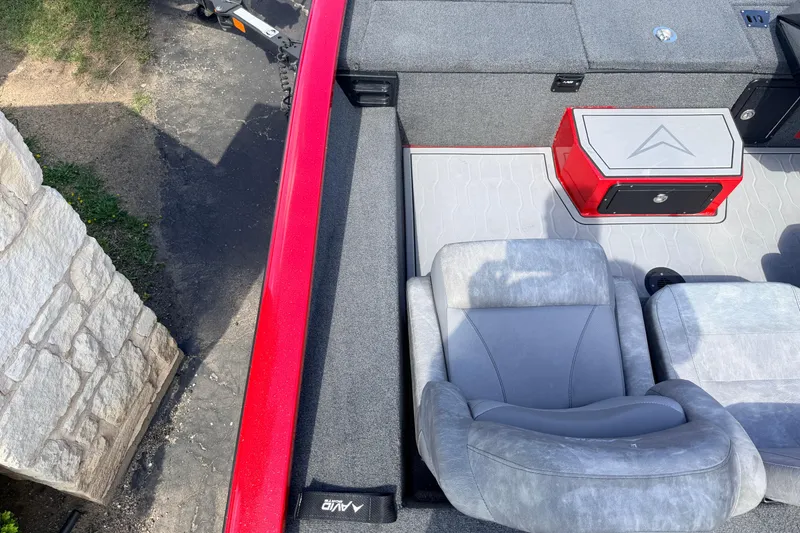Slide: The Image of 2023 Avid 20 XB boat interior with gray seating and red storage compartment. - 17