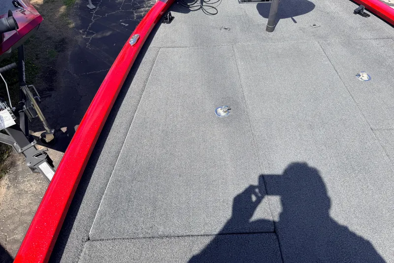 Slide: The Image of 2023 Avid 20 XB boat deck with red trim and shadow. - 19