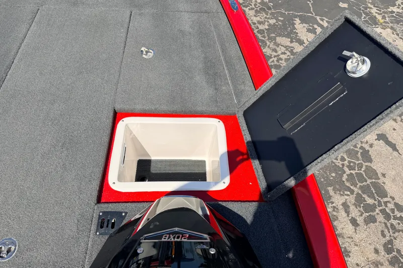 Slide: The Image of 2023 Avid 20 XB boat storage compartment with open hatch, red and gray interior. - 22