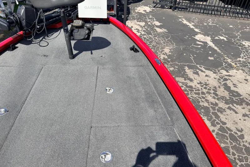 Slide: The Image of 2023 Avid 20 XB boat deck with Garmin equipment, featuring a red trim and gray carpet. - 23