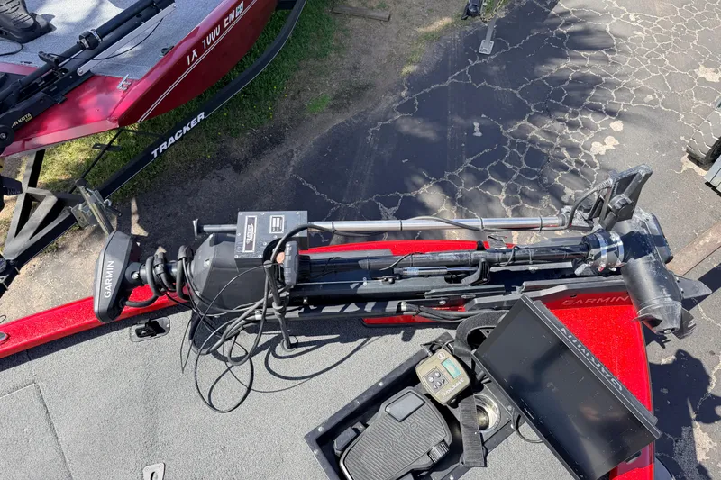 Slide: The Image of 2023 Avid 20 XB boat with Garmin equipment and Tracker trailer, parked on cracked pavement. - 29