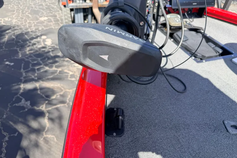 Slide: The Image of Red Avid 20 XB boat with Garmin equipment, 2023 model, on textured pavement. - 32