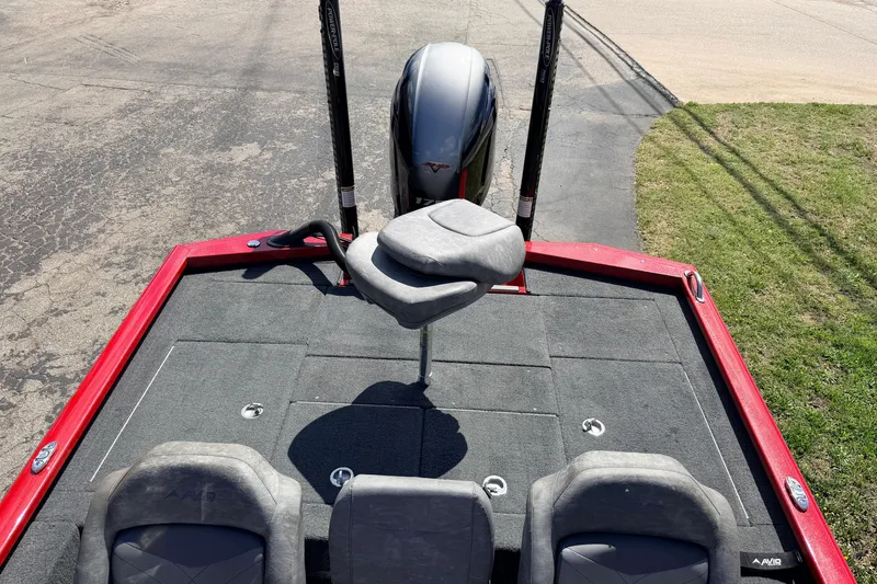 Slide: The Image of 2023 Avid 20 XB boat with gray seating and red trim, parked on pavement. - 33
