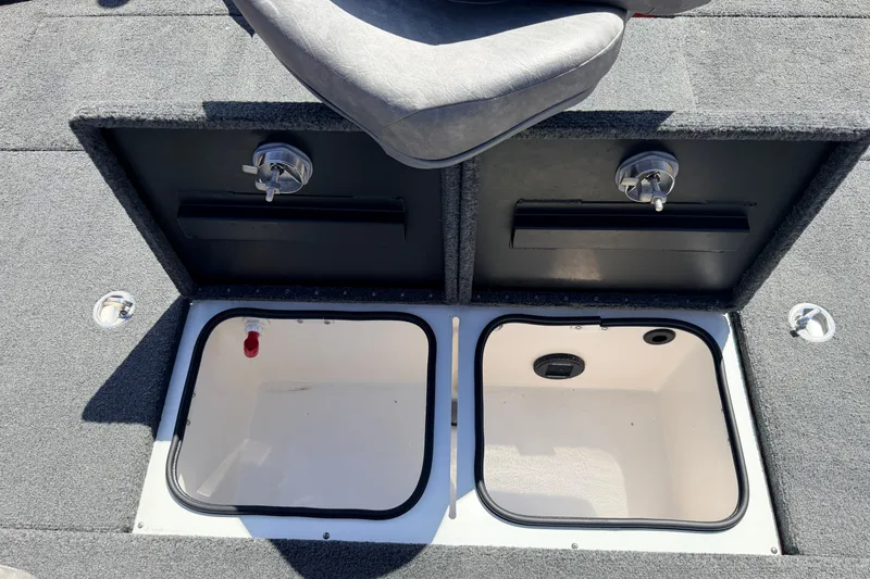 Slide: The Image of 2023 Avid 20 XB boat storage compartments with gray seating and carpeted surface. - 34