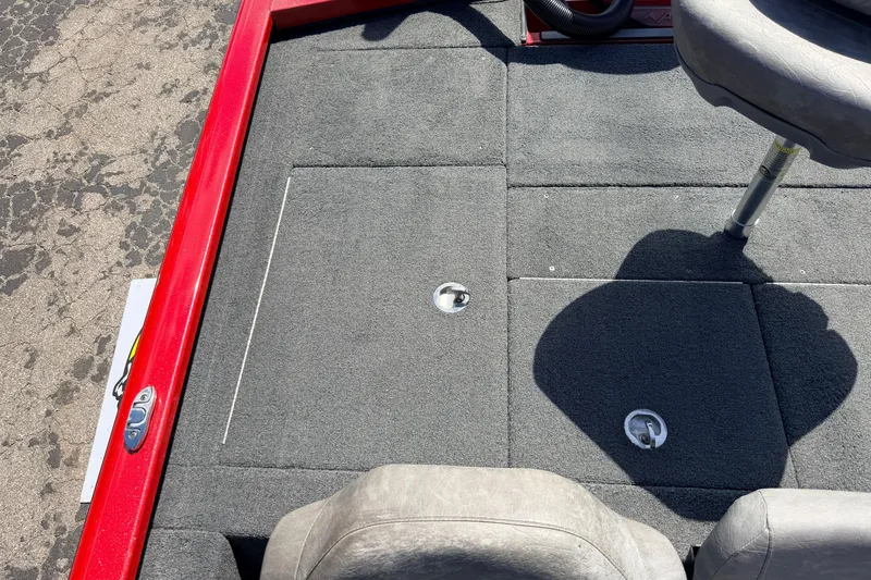 Slide: The Image of 2023 Avid 20 XB boat interior with gray carpet and red trim. - 36