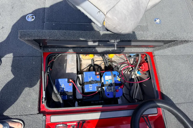 Slide: The Image of Open battery compartment in 2023 Avid 20 XB boat, showing wiring and batteries. - 39