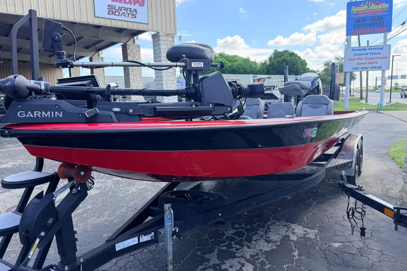 Slide: The Image of 2023 Avid 20 XB boat with Garmin equipment on a trailer, parked outside dealership. - 4