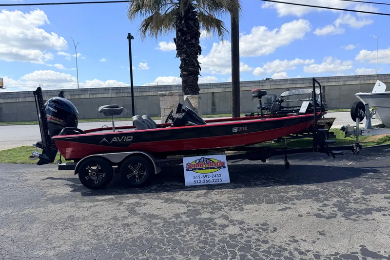 Slide: The Image of 2023 Avid 20 XB boat on trailer, parked outdoors under a clear sky. - 40