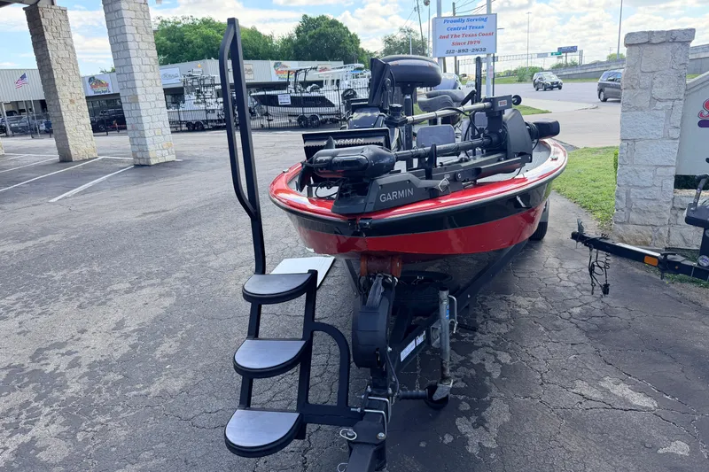 Slide: The Image of 2023 Avid 20 XB boat with Garmin equipment on a trailer in a parking lot. - 5