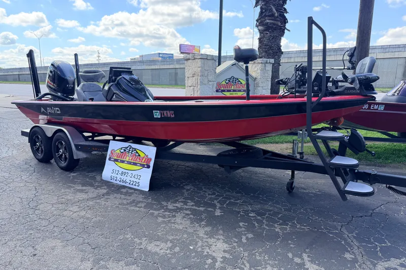 Slide: The Image of 2023 Avid 20 XB boat on trailer, displayed outdoors with dealership sign. - 6