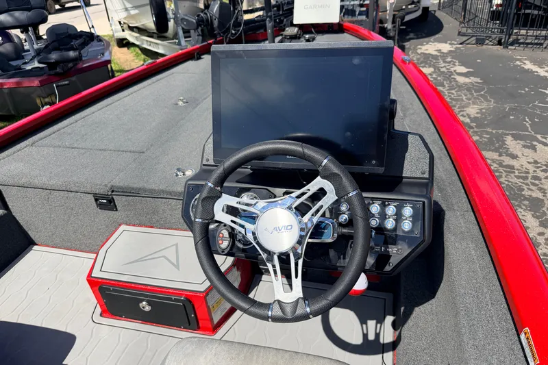 Slide: The Image of 2023 Avid 20 XB boat dashboard with steering wheel and electronic display. - 7